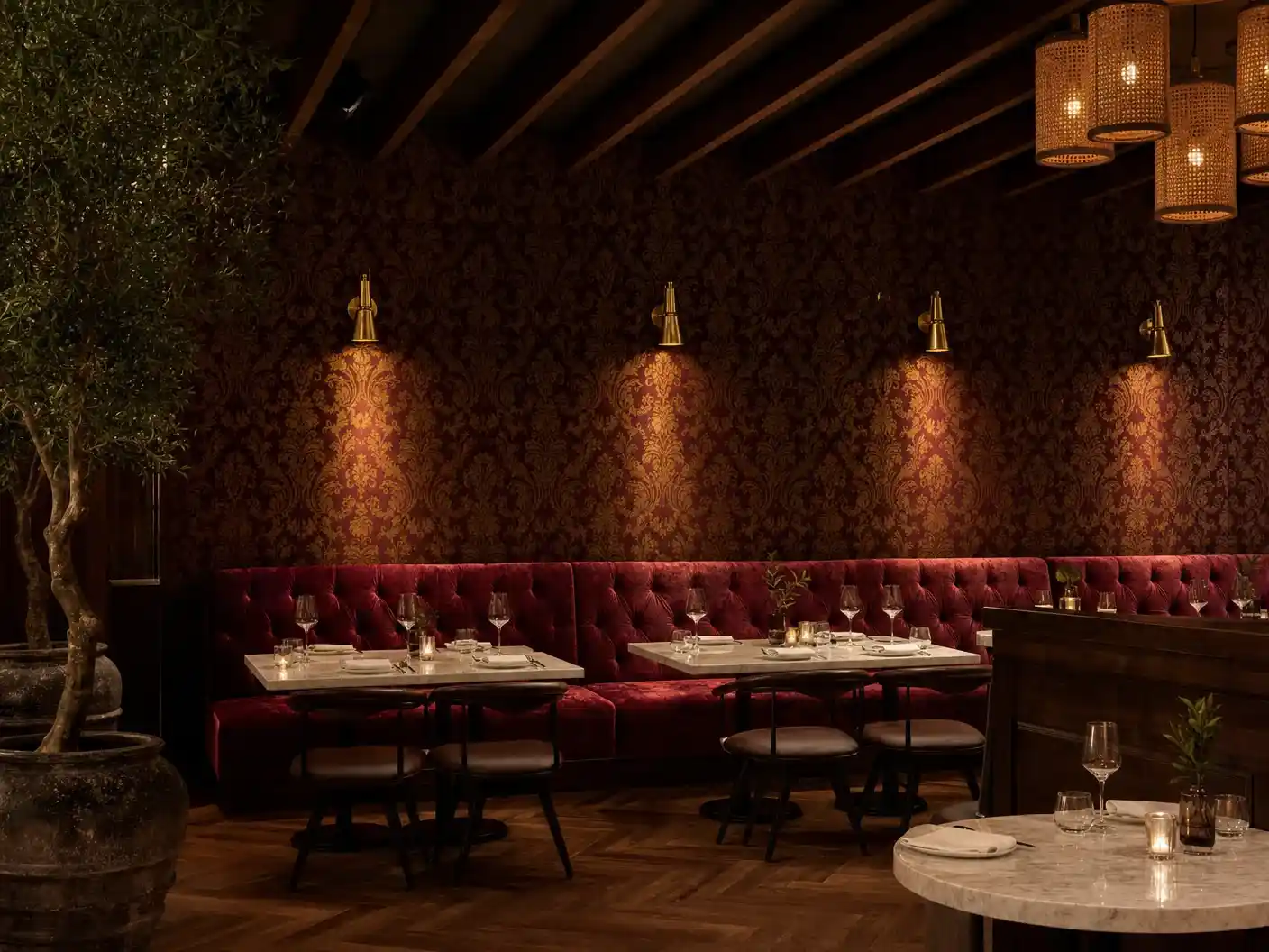 LA restaurant with oxblood damask wallpaper above velvet banquette